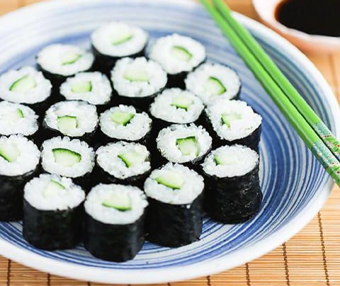 This is a picture of a bunch of cucumber rolls bunched together.